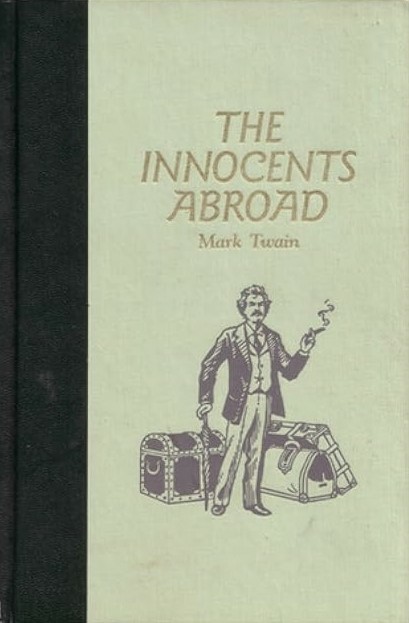 The front cover of Mark Twain's "The Innocents Abroad", showing a drawing of the author smoking a cigar and leaning on his closed umbrella as he stands in front of his baggage.