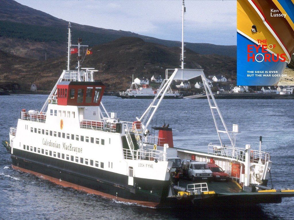 This image shows two Skye ferries in 1992. In the foreground is “Loch Fyne” with its prow in the bottom right of the image. The ferry has a white structure above a black lower hull. The deckhouse is red and the vehicle ramp is being lowered. In the distance is a second ferry at the slipway in Kyleakin, with the village in the upper right of the frame and a hillside climbing behind it and in the upper left. The front cover of ‘The Eye of Horus’ is shown in the top right corner.