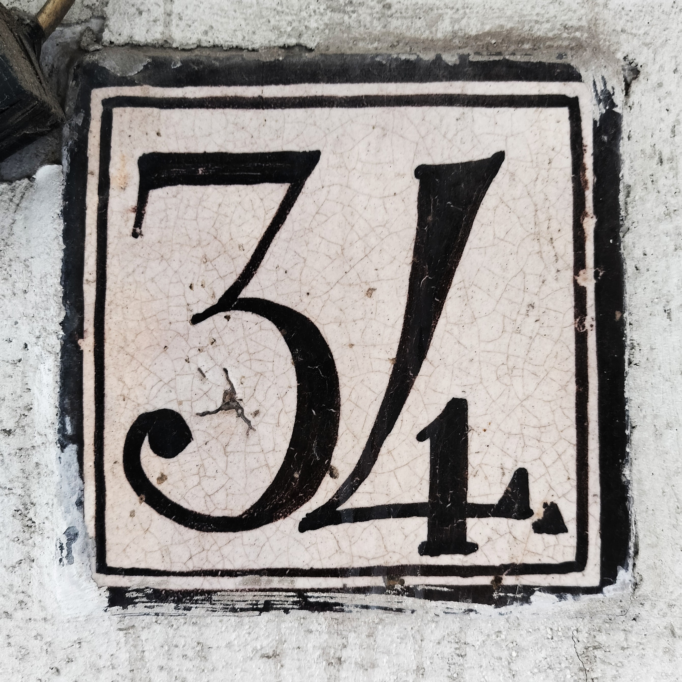 The number 34 in a high contrast serif. The number 4 is extreme, basically resembling a 7 rotated 180° with a tiny vertical line crossing the horizontal stroke.