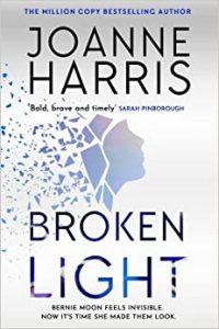 The  cover of the book "Broken Light" by Joanne Harris.

The author's name is in a black block capital typeface against a light gray background.
The title is in the same typeface.

Between the author's name and the title, there is a blue silhouette of a profile of a woman's head that is breaking into fragments.

* Another Duchess of Spring Alt-text production ™