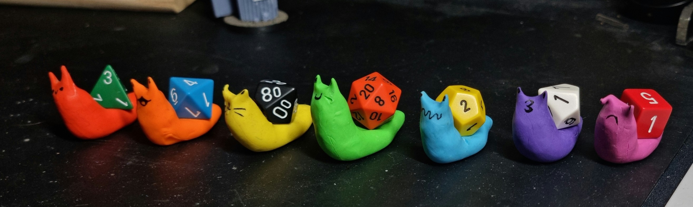 7 multi coloured snails but the shells on their backs are different sided roleplay dice