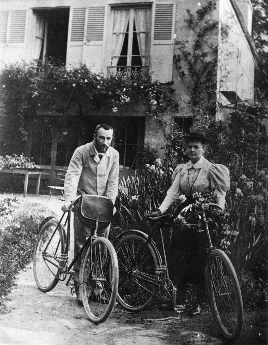 (L-R) Pierre Curie and Marie Curie stand with their bicycles. Credit: Photo from Laboratoire Curie, Institut de Physique Nucleaire, courtesy AIP Emilio Segrè Visual Archives. Catalog ID: Curie Pierre C7