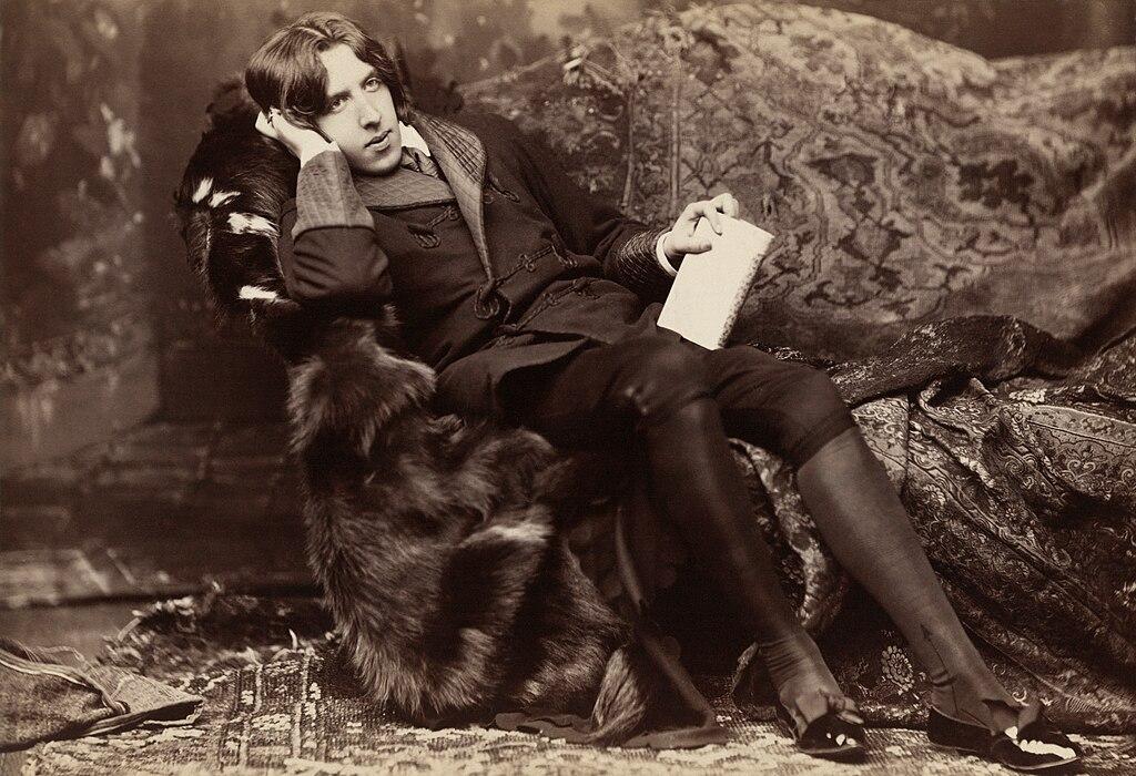 Wilde reclining with Poems, by Napoleon Sarony in New York in 1882. 

Wilde often liked to appear idle, though in fact he worked hard; by the late 1880s he was a father, an editor and a writer.