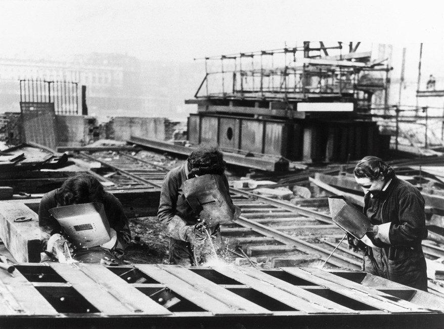 Three women acetylene welders cutting the girders of the temporary Waterloo Bridge