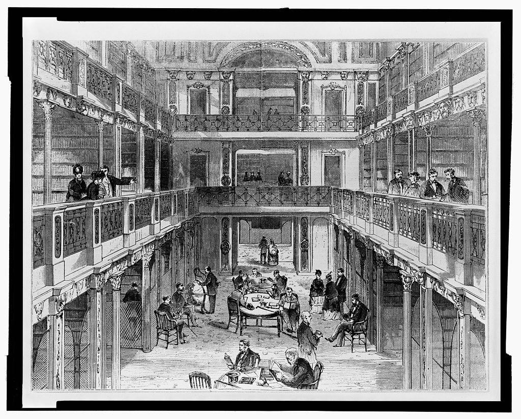 Library of Congress in the Capitol Building in 1853.

Ornamental columns and arches in the neoclassical style, symbolizing strength and permanence.

Wooden shelves, likely reaching high, filled with bound volumes, representing the library’s growing collection at the time.

Sunlight streaming through large windows or skylights, illuminating the space with a warm, diffused glow.

Sturdy, elegant furniture arranged for study and research, reflecting the purpose of the library.

Early gas lamps or chandeliers providing artificial light, as electricity was not yet in use.

A few individuals working, cataloging, or reading, dressed in mid-19th-century attire.