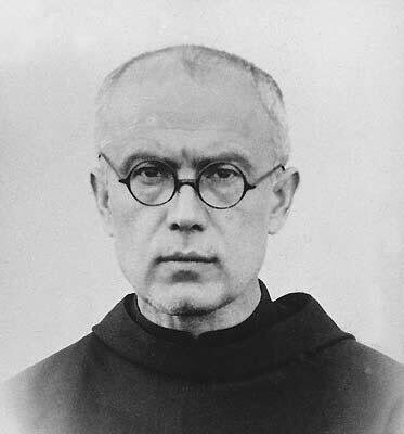 A Franciscan monk in dark round glasses. He has very short grey hair. 