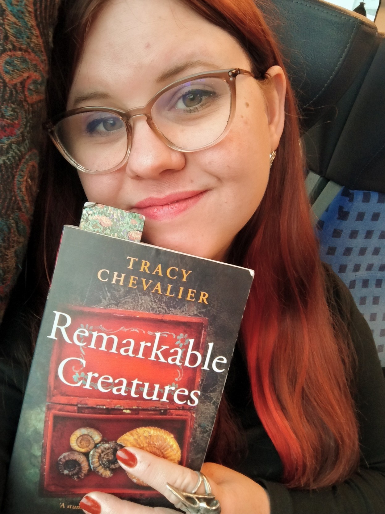 Me holding "Remarkable creatures" by Tracy Chevalier.