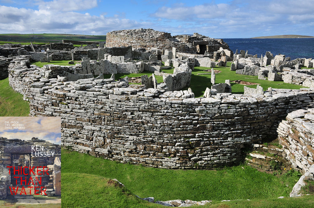 The image shows an enormous curving structure formed from unmortared walls of nearly white stone. There’s a ditch in the foreground with a massive, curved wall on its far side. Beyond that are numerous low stone structures with a higher circular stone wall beyond them. On the right is blue sea, with an island beyond it. The scene is in sunlight. The front cover of ‘Thicker Than Water’ is shown in the bottom left corner.