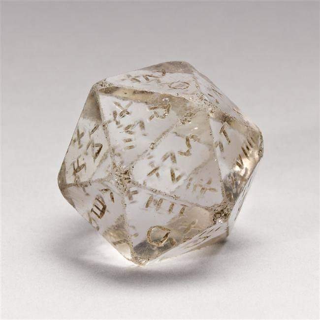 Fully transparent icosahedron as a 20-sided die with Latin letters etched into each side.