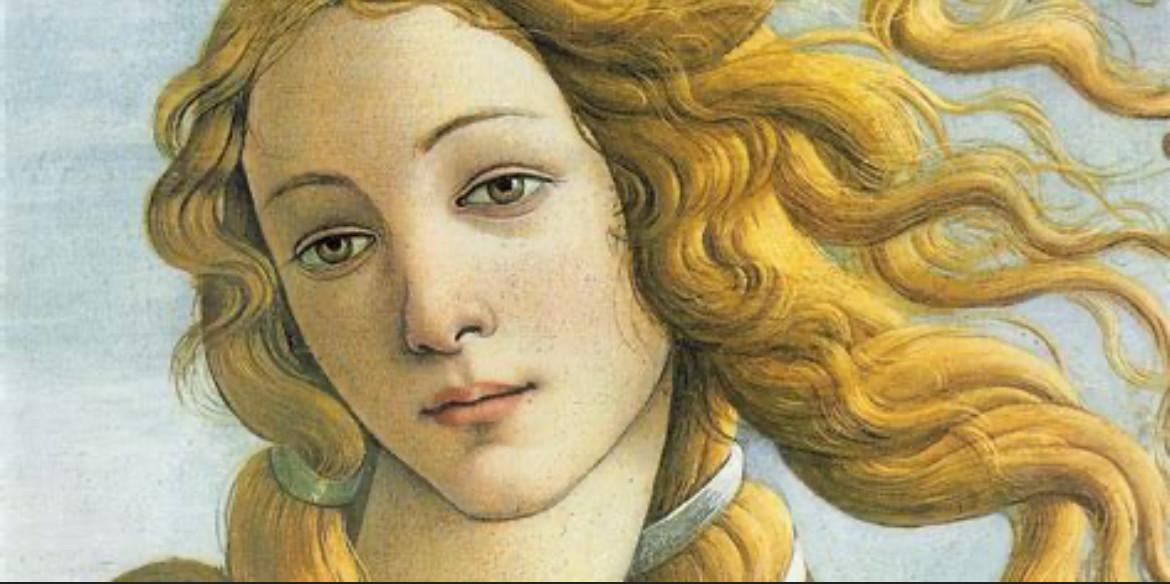 Close up of Aphrodite from Botticelli’s ‘The Birth of Venus’. She has a serene expression of flowing golden hair.