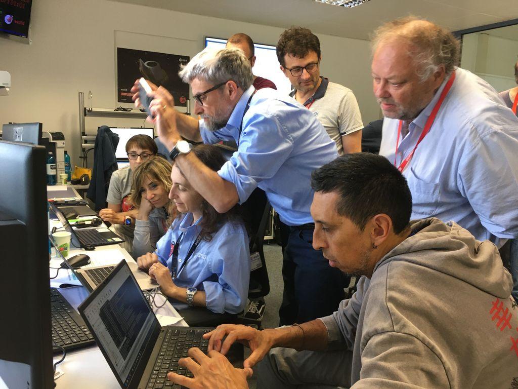 NISP instrument team gathered around their first spectra image. Credit: Reiko Nakajima