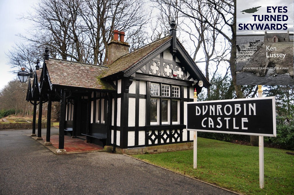 Dunrobin Castle Station. The image shows a corner view of a black and white half-timbered chalet style building with a sheltered area to its front, or our left. There is a tarmac-covered area in front of it and a grassy area to its sides and behind, and leafless trees in the background. A sign in the bottom right of the frame says Dunrobin Castle in white on black. The front cover of ‘Eyes Turned Skywards’ is shown in the top right corner.