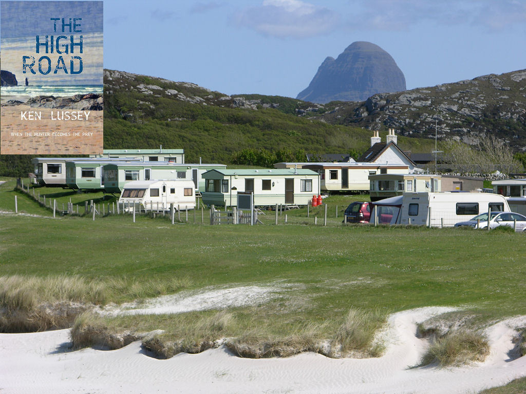 The image shows part of Achmelvich in Sutherland, with the top of the white sand beach visible in the foreground, then sandy grass and a caravan site with static and touring vans. Beyond the site the land rises to a rocky ridge and in the upper right of the frame is the distinctive policeman’s-helmet shape of Suilven, a mountain inland from Lochinver. The scene is in sunlight. The front cover of ‘The High Road’ is shown in the top left corner.