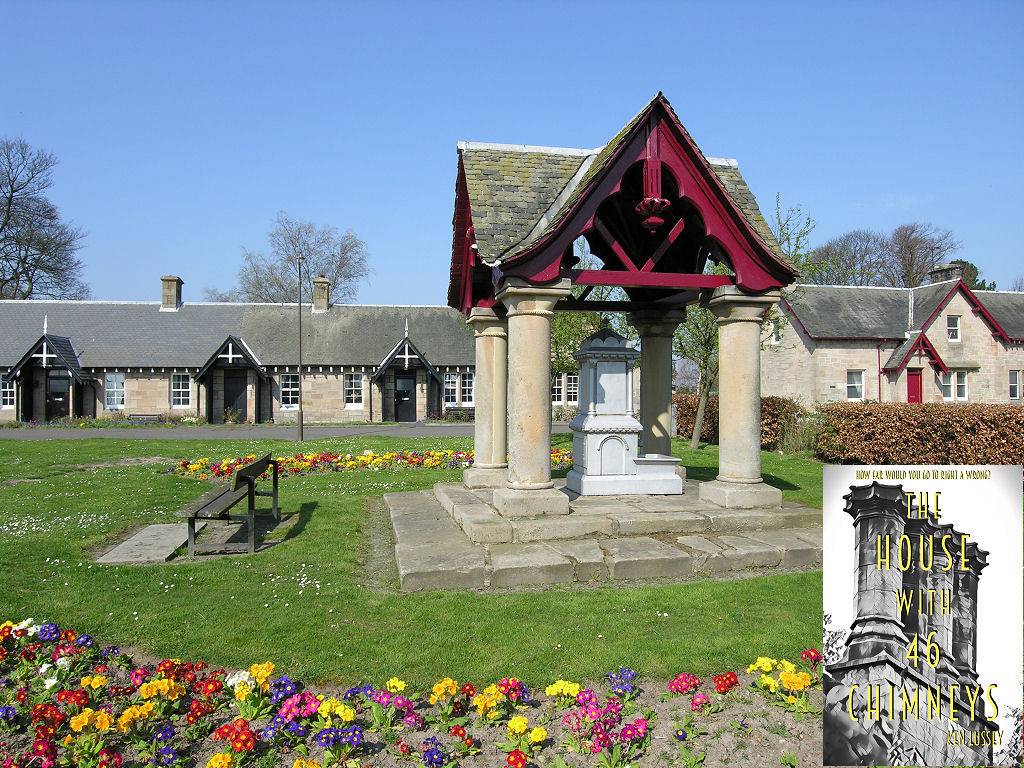 Dunmore. The image shows a village green with an ornate drinking fountain with columns supporting its substantial roof to the right centre of the frame. There’s a park bench to its left, facing left, and flowers across the foot of the frame. A row of cottages stretches across the frame beyond a narrow road which is itself beyond the green. The sky is blue. The front cover of ‘The House With 46 Chimneys’ is shown in the bottom right corner.