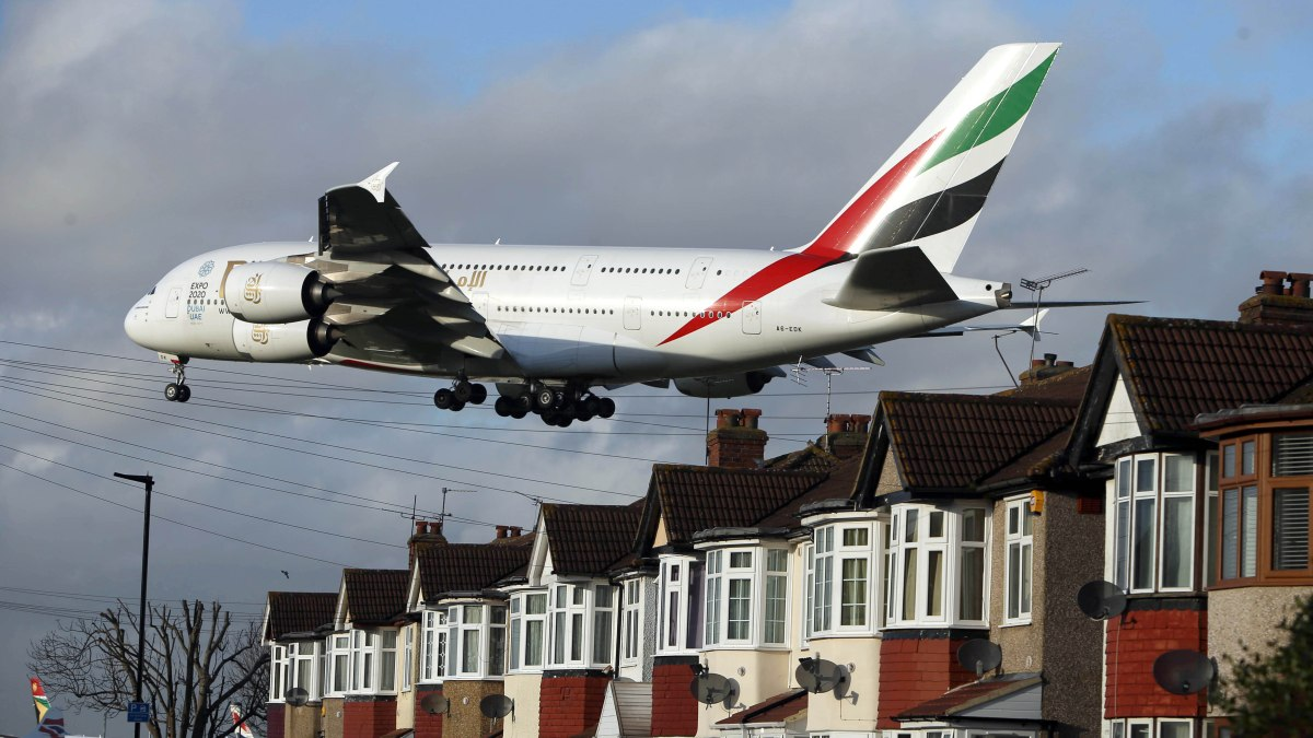 Photo: an airliner taking off over houses near Heathrow