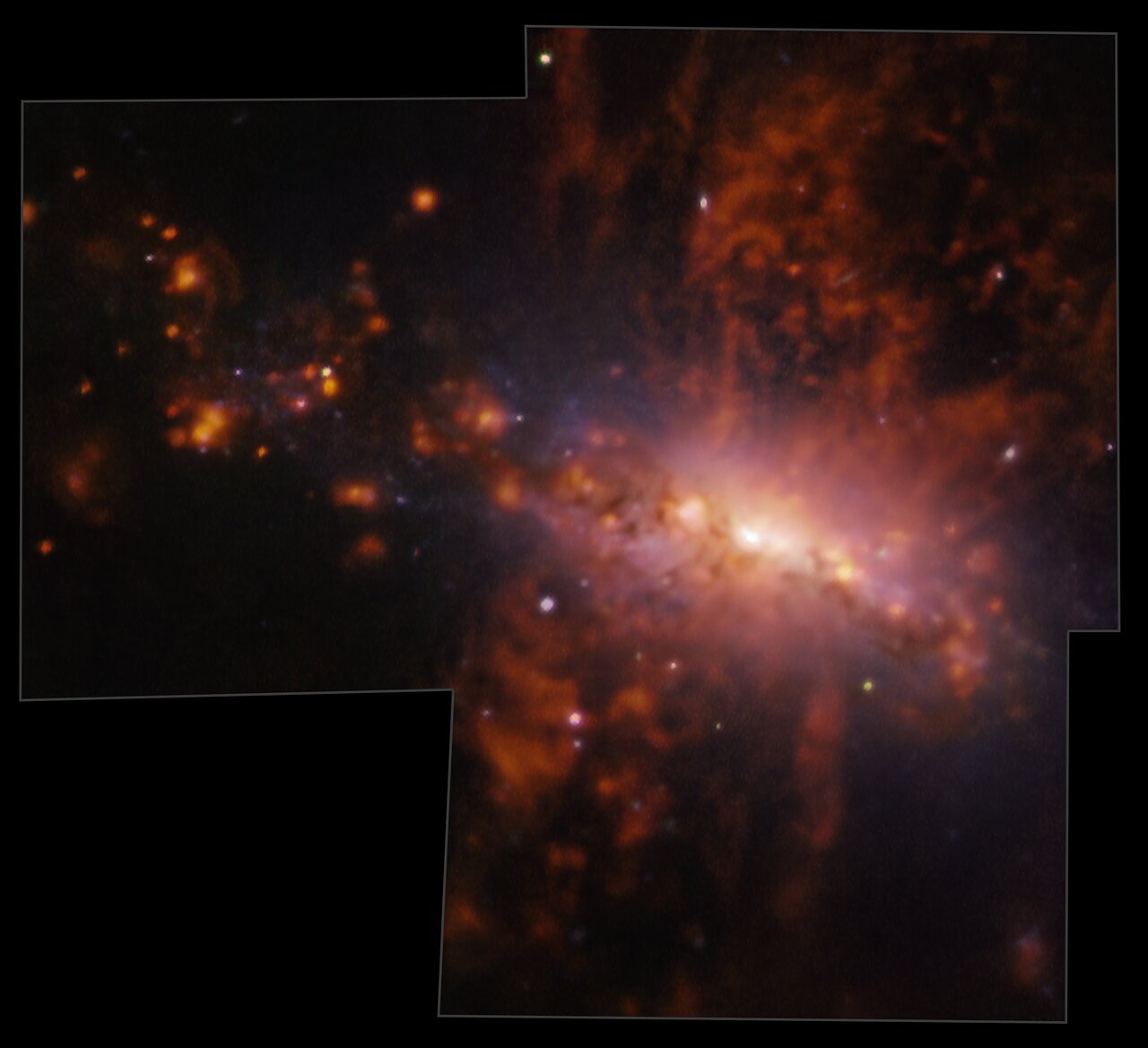 A bright yellow/orange cloud against a black background. Lots of wispy red tendrils emerge above and below this cloud. Bright, compact red knots are also dotted across the image.