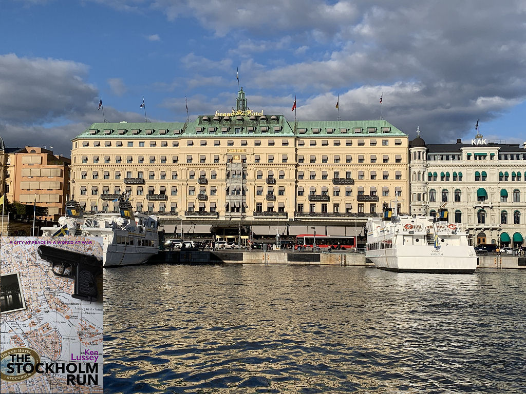 The image shows a modern view across the harbour of Stockholm’s Grand Hotel in sunlight. It’s eight storeys high and extends across most of the frame. There are two passenger vessels moored nose on to the quay, so with their rears facing the camera. The scene is in sunshine. The front cover of 'The Stockholm Run' is shown in the bottom left corner.