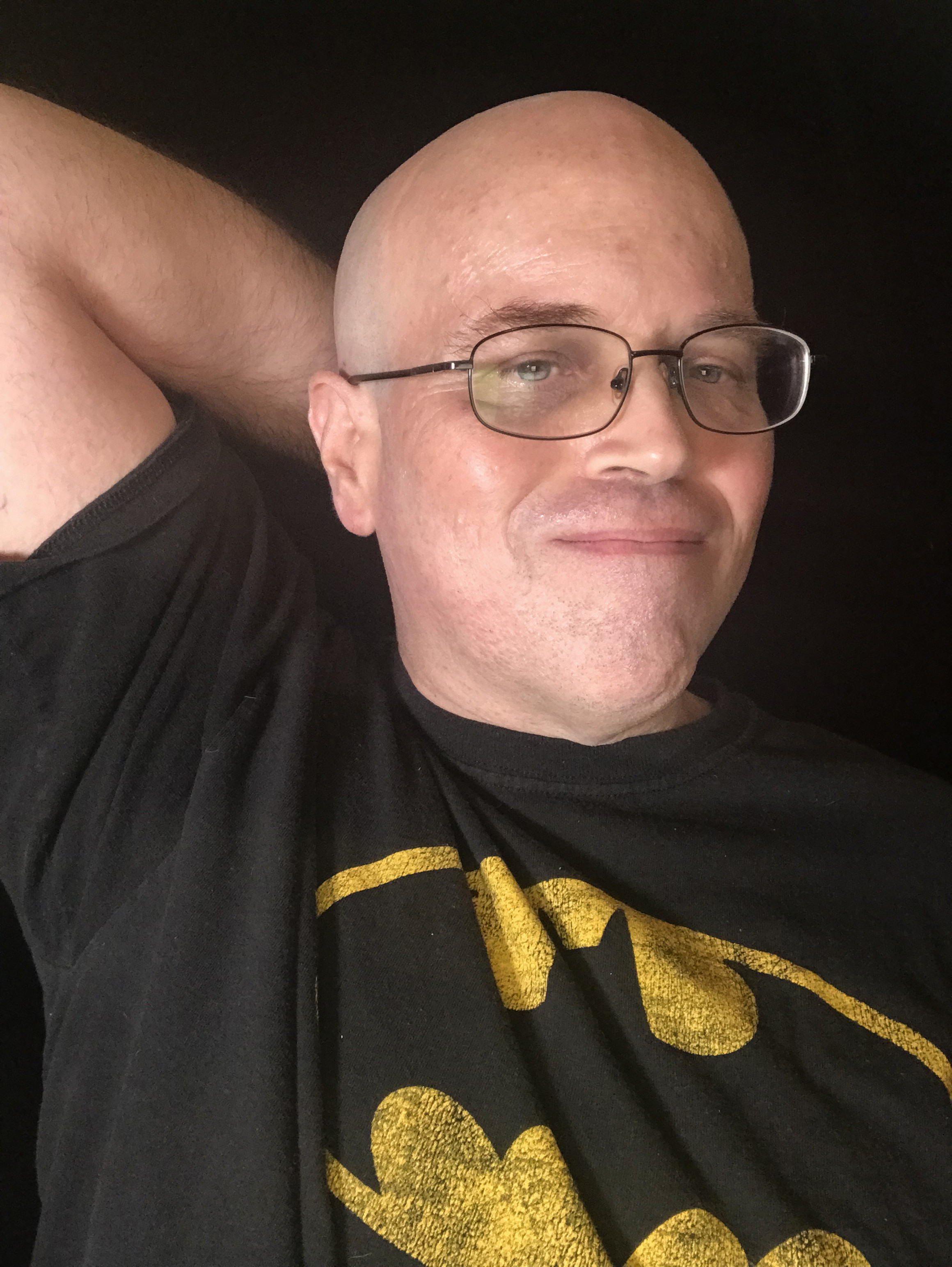 Me - the person behind this account. Bald man with glasses smiling  and wearing a Batman T-shirt. 