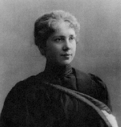 Portrait of Harriet Brooks.

A stylishly dressed woman in a black and white picture.